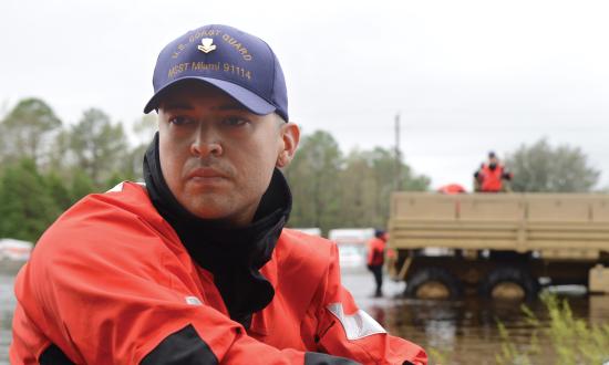 A member of Coast Guard Maritime Safety and Security Team Miami drives a shallow-water craft through floodwater caused by Hurricane Florence