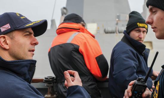 A destroyer commanding officer mentors a junior officer during a training exercise. The most important thing a new division officer can do is listen—and learn.