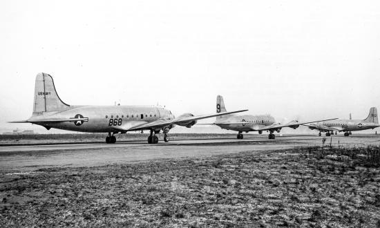 Two R5Ds of Naval Air Transport Squadron 8 (VR-8) sandwich an Air Force C-54 as they await their turn for takeoff from Rhein-Main Air Base in January 1949