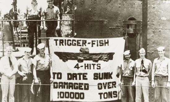 Trigger (SS-237) crew pose with a sign showing the submarine’s reported toll on Japanese shipping. The carrier depicted is the Hiyō, on which four hits were claimed.