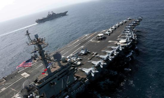 Large nuclear-powered aircraft carriers, such as the USS Abraham Lincoln (CVN-72), shown here, deliver much more combat power than smaller “Lightning” carriers, such as the USS Kearsarge (LHD-3), shown in the distance.