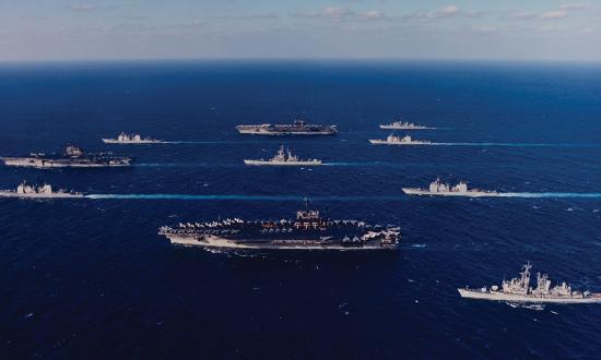 Ten ships of Task Force 155 gather during Operation Desert Storm. Leading the formation at left is the USS Saratoga (CV-60), flanked by the San Jacinto (CG-56), top, and Thomas Gates (CG-51). At center is the USS Mississippi (CGN-40), flanked by the America (CV-66), top, and John F. Kennedy (CV-67). At rear are, from top, the USS Preble (DDG-46), Philippine Sea (CG-58), Normandy (CG-60), and William V. Pratt (DDG-44).