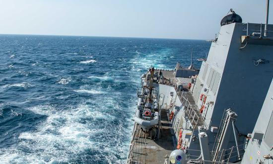 The USS Gravely (DDG-107) escorts a merchant vessel through Bab al-Mandeb on 12 January. 