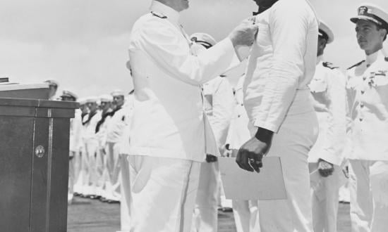 Admiral Chester Nimitz (left) awards the Navy Cross to Messman Third Class Doris “Dori” Miller.