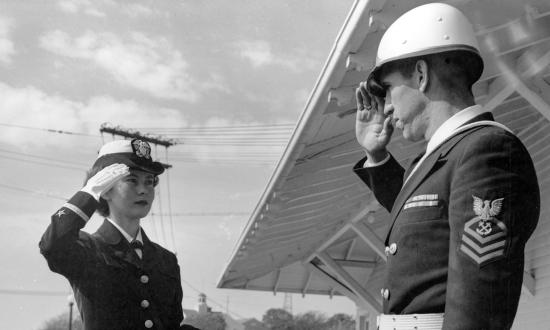 A newly minted ensign exchanges farewell salutes with a chief at OCS in Newport, Rhode Island