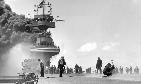  Crewmen repair bomb damage to the flight deck of the USS Yorktown (CV-5) on 4 June 1942 during the Battle of Midway