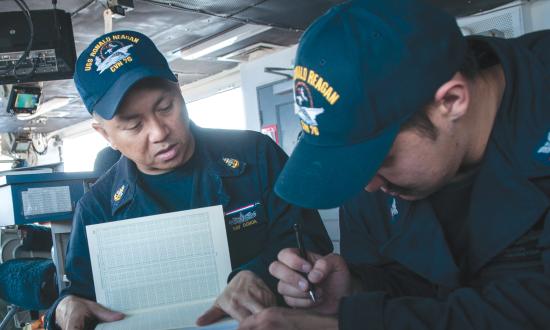 Senior Chief Engineman Jason Saffa mentors Engineman Second Class Quanesha Jenkins on board the USS Rushmore (LSD-47) while deployed.