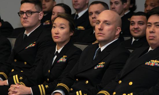 Department heads listen to a speaker during their graduation from Surface Warfare Schools Command (SWSC). Cold War–era surface warfare department heads received training at classifications above secret, but in the past two decades this was cut from SWSC.