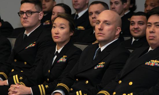 Department heads listen to a speaker during their graduation from Surface Warfare Schools Command (SWSC). Cold War–era surface warfare department heads received training at classifications above secret, but in the past two decades this was cut from SWSC.