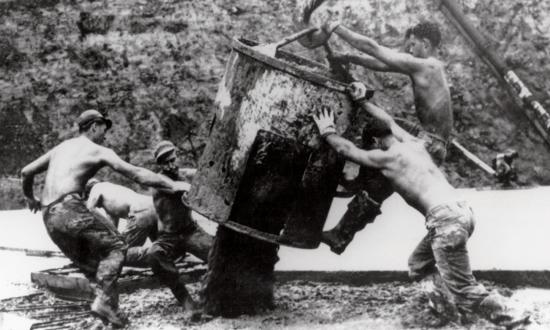 Seabees unload a concrete bucket at Cubi Point, the Philippines. In the 1950s, Seabees built Cubi Point Naval Air Station—something civilian contractors claimed was impossible given the mountainous, jungle-covered terrain.