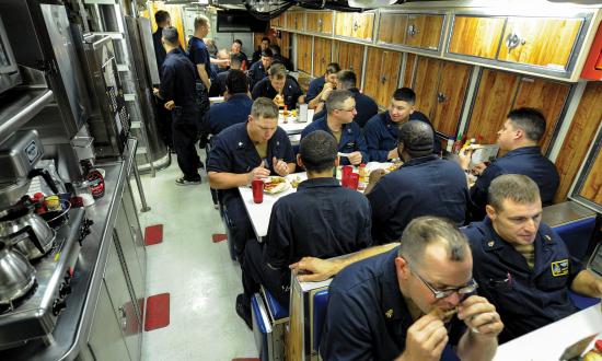 Sailors assigned to the Virginia-class fast attack submarine USS Indiana (SSN-89) eat dinner in the crew’s mess while under way