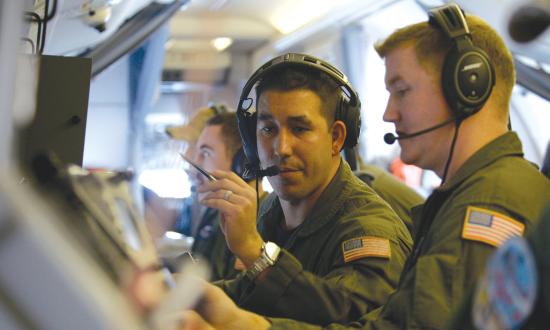N SEA (Nov. 17, 2016) Petty Officer 2nd Class Luis Hernandez, center, and Petty Officer 2nd Class Kenneth Lovett conduct acoustic operator duties aboard the P-8A Poseidon aircraft during a qualification training, Nov. 17, 2016