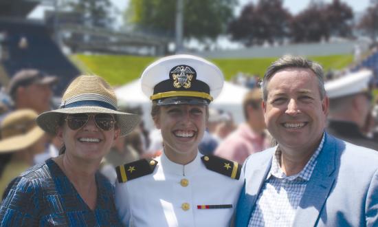Thomas and Elizabeth Furlong flanking their daughter Paige after her USNA Graduation