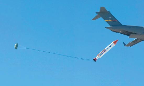 U.S. Air Force C-17 air-launching an intermediate-range ballistic missile mockup out of its rear cargo door.