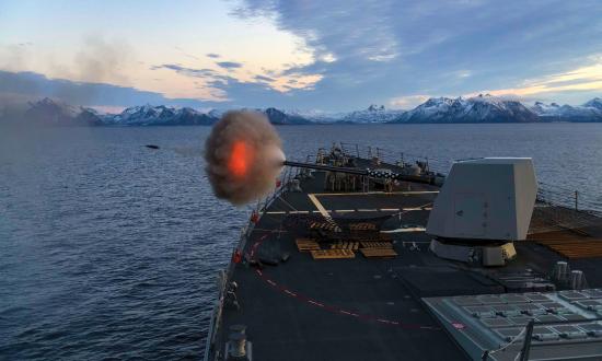 A destroyer fires its Mark 45 5-inch gun.