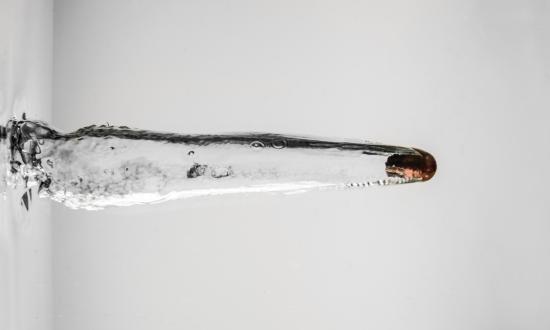 Bullet being fired through water showing supercavitation effect