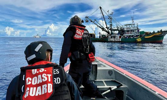 Crew members from the USCGC Oliver Henry (WPC-1140) approach a fishing vessel in the Pacific Ocean in March 2023.