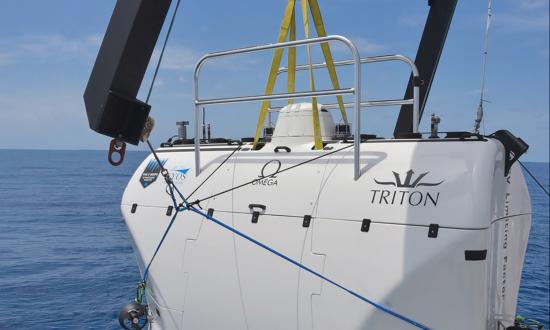 the Triton 36000/2 deep submergence vehicle hoisted above the ocean surface