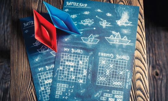 Stock image of game board with paper ships