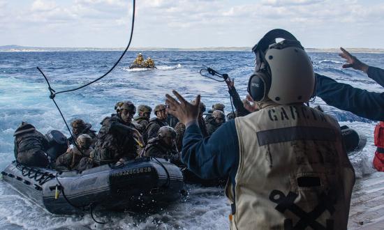Sailors assigned to the amphibious transport dock USS Green Bay (LPD-20) receive a recovery line from Marines with the Battalion Landing Team 1/1, 31st Marine Expeditionary Unit, during a bilateral boat raid exercise off the coast  of Okinoerabu, Japan.