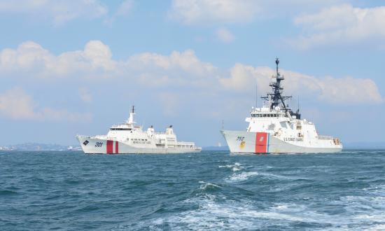 The Coast Guard Cutter Stratton (WMSL-752) sails alongside the Indonesian BAKAMLA vessel KN Tan Jung Datu in the Singapore Strait