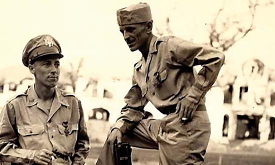 Lieutenant Ramsey (right) and one of his commanders, Major John Boone, stand amid the rubble of Manila. Both were awarded the Distinguished Service Cross in 1945. 