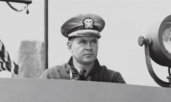 Bulkeley, commander of PT Squadron Three, shown on the bridge of a PT boat during the Battle of the Philippines.