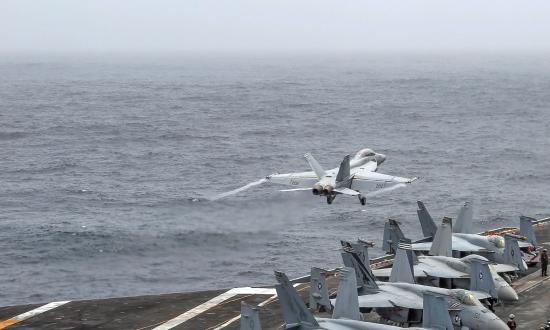 An F/A-18 Super Hornet attached to Strike Fighter Squadron 143 launches from the flight deck of the USS Abraham Lincoln (CVN-72) in the U.S. Fifth Fleet area of operations