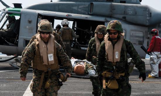 U.S. Navy sailors assigned to the 3rd Medical Battalion and Royal Thai Navy medical personnel carry a simulated patient from a UH-1Y Huey helicopter assigned to the Marine Light Attack Helicopter Squadron (HMLA) 267 on the flight deck of the amphibious transport dock ship USS Green Bay (LPD-20) during a casualty evacuation exercise.