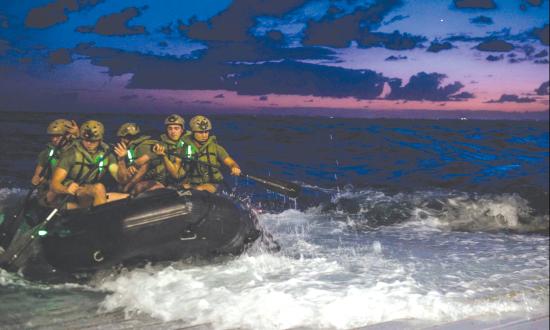 Marines depart the well deck of the amphibious transport dock ship USS Green Bay (LPD 20) in a combat rubber raiding craft (CRRC)