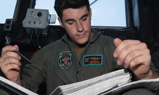 A naval aircrewman studies a training manual on board the USS Tripoli (LHA-7). By using LLMs to shortcut the search for information, the Navy could revolutionize training and operations. The service needs a certified LLM for use on classified information networks as a reference-based database on board ships.