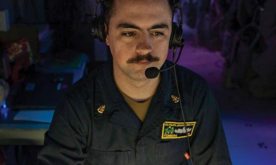 A cryptologic technician (technical) chief stands watch in the combat information center (CIC) of the guided-missile destroyer USS Ralph Johnson (DDG-114) deployed to the western Pacific. Many cryptologic warfare officers and cryptologic technician chief petty officers find themselves standing watch in the ship’s CIC instead of focusing on cryptologic operations in the ship’s signals exploitation space.