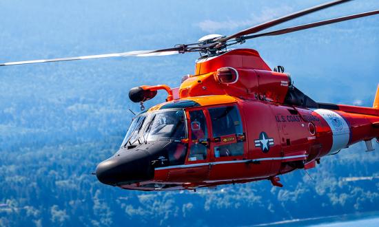 An MH-65 Dolphin conducts a formation flight over Port Angeles, Washington. 