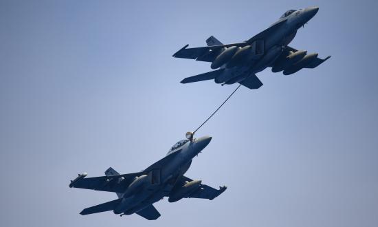 An F/A-18 Super Hornet assigned to Strike Fighter Attack Squadron 113 refuels an EA-18G Growler assigned to Electronic Attack Squadron 139