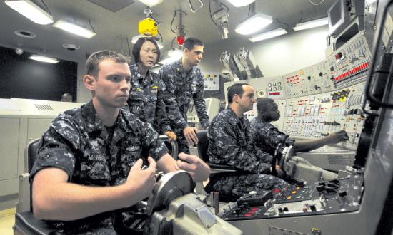 A junior officer of the Blue crew on board the USS Ohio (SSGN-726) supervises a simulated dive as diving officer of the watch in the Ship Control Trainer at Trident Training Facility Bangor, Washington
