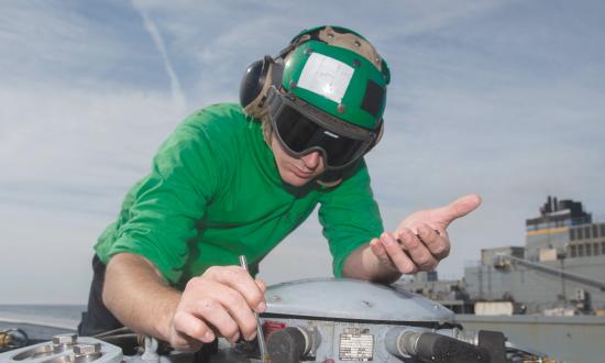 Aviation Electrician’s Mate Third Class Howard Weld conducts maintenance on an MH-60R Sea Hawk helicopter