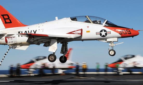 A T-45 Goshawk assigned to Carrier Training Wing 2 makes an arrested landing on the flight deck of the Nimitz-class aircraft carrier USS Abraham Lincoln (CVN-72). Training command carrier qualification exposes students to a stressful environment in a low-cost aircraft with as many safeguards as possible and should not be eliminated.