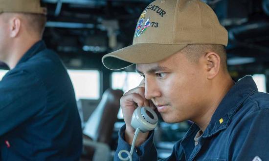 The assistant officer of the deck relays maneuvering intentions to the combat information center on board the guided-missile destroyer USS Decatur (DDG-73). The process for a surface warfare officer to use his or her sea time and shiphandling experience to pursue a civilian mariner license is cumbersome, confusing, and unfair to those not commissioned from the U.S. Naval Academy or one of the federal or state maritime academies.