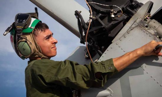 A Marine Corps aviation technician conducts maintenance on a UH-1Y Huey on Marine Corps Air Station New River in Jacksonville, North Carolina. U.S. Marine Corps (Trey Michael)