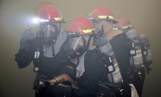 Sailors assigned to the USS Gerald R. Ford (CVN-78) respond to a simulated fire in the hangar bay. Because Navy sailors are responsible for fighting ships, rather than just operating them, a merchant mariner crew-rest standard should not be completely adopted.