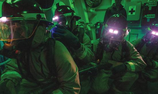 Sailors on board the Arleigh Burke–class guided-missile destroyer USS Roosevelt (DDG-80) man a hose during a damage control drill. 