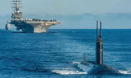 The USS Ronald Reagan (CVN-76), a Los Angeles–class fast-attack submarine, and Japan Maritime Self-Defense Force destroyer Asahi steam in formation in waters east of the Korean Peninsula.