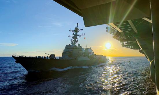 The Arleigh Burke–class guided-missile destroyer USS Daniel Inouye (DDG-118) comes alongside the Nimitz-class aircraft carrier USS Theodore Roosevelt (CVN-71) for replenishment on 25 January 2024. 