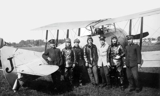 A Sempill Mission British flying instructor stands with Japanese naval aviators