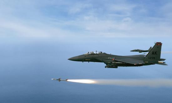 Two F-15E from the 90th Fighter Squadron, Elmedorf AFB, Alaska, fire a pair of AIM-7M's during a training mission