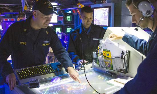 U.S. Navy and Japan Maritime Self-Defense sailors plot subsurface contacts
