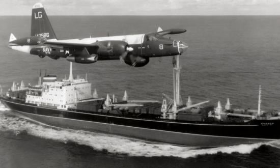 A P2V Neptune U.S. patrol plane flying over a Soviet freighter during the Cuban Missile Crisis in October 1962.