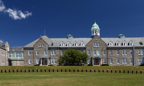 The U.S. Naval War College’s (NWC) Luce Hall on Coasters Harbor Island in Newport, Rhode Island. Officer education should include research on new concepts that inform Navy force development efforts.