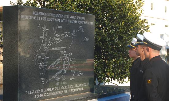 Midshipmen Fourth Class Joseph Lynch, Stevie Greenway, and Marc Cardwell (left to right) study the U.S. Naval Academy’s Midway Monument.