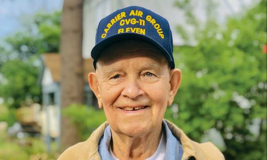 Verg Bloomquist posing with the August 2019 issue of Naval History